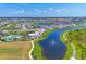 Gorgeous aerial view of a lakefront community with pool, clubhouse, and manicured landscaping on a sunny day at 17122 Ranchside Pl, Bradenton, FL 34211