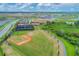 An aerial view of the community ball field and tennis courts, surrounded by lush landscaping and green spaces at 17122 Ranchside Pl, Bradenton, FL 34211