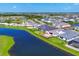 Aerial view of a community with homes surrounding a lake at 17122 Ranchside Pl, Bradenton, FL 34211