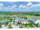 Aerial shot displays community pool and amenity center at Star Farms with houses and greenery at 17122 Ranchside Pl, Bradenton, FL 34211