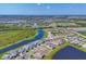 An expansive aerial view of a Primary-planned community with homes, lakes, and green spaces under a sunny sky at 17122 Ranchside Pl, Bradenton, FL 34211