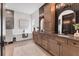 Modern bathroom featuring double vanities, a soaking tub, and elegant fixtures, creating a spa-like experience at 17122 Ranchside Pl, Bradenton, FL 34211