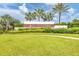 Landscaped entrance sign for Star Farms at Lakewood Ranch, framed by green grass and palm trees under a blue sky at 17122 Ranchside Pl, Bradenton, FL 34211