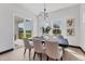 Stylish dining area with modern lighting and a serene view of outdoor landscape perfect for an intimate gathering at 17122 Ranchside Pl, Bradenton, FL 34211