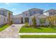 Beautiful two-story home featuring a one-car garage, stone accents, and professionally landscaped yard at 17122 Ranchside Pl, Bradenton, FL 34211