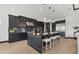 Gourmet kitchen boasts sleek black cabinetry, stainless steel appliances, and a large center island with bar seating at 17122 Ranchside Pl, Bradenton, FL 34211