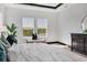 Bright main bedroom featuring two large windows with picturesque outdoor views and stylish decor at 17122 Ranchside Pl, Bradenton, FL 34211