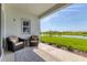 Comfortable covered patio with seating and a beautiful view of the water at 17122 Ranchside Pl, Bradenton, FL 34211