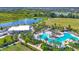 A stunning aerial view of a large, uniquely shaped pool surrounded by lush landscaping and lounge chairs at 17122 Ranchside Pl, Bradenton, FL 34211