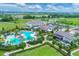 A wide angle view highlights the pool surrounded by outdoor dining and recreation space, including lush tropical landscaping at 17122 Ranchside Pl, Bradenton, FL 34211