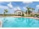 An inviting pool area features a cabana for shaded relaxation, along with tables and chairs for outdoor gatherings at 17122 Ranchside Pl, Bradenton, FL 34211