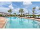 Community pool with rows of cushioned lounge chairs facing the clear, refreshing water for resident relaxation at 17122 Ranchside Pl, Bradenton, FL 34211