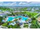 Bird's eye view of the community pool featuring lounge areas, cabanas, and verdant landscaping for relaxation and enjoyment at 17122 Ranchside Pl, Bradenton, FL 34211