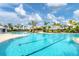 Spacious community pool offers separate areas for lap swimming and leisurely activities surrounded by lush landscaping and seating at 17122 Ranchside Pl, Bradenton, FL 34211