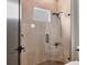 Modern glass shower featuring a tiled wall, rain shower head, and a corner shelf at 17122 Ranchside Pl, Bradenton, FL 34211