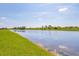 Scenic view of a peaceful lake surrounded by lush green grass at 17122 Ranchside Pl, Bradenton, FL 34211