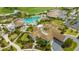 Aerial shot of the clubhouse featuring a pool, outdoor seating, and lush landscaping in a sunny environment at 17704 Gawthrop Dr # 303, Lakewood Ranch, FL 34211