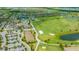 An aerial view of the community featuring a golf course, driving range, clubhouse with pool, and residential housing at 17704 Gawthrop Dr # 303, Lakewood Ranch, FL 34211