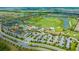 An aerial view of the lush community featuring multiple pools, a clubhouse, and golf course at 17704 Gawthrop Dr # 303, Lakewood Ranch, FL 34211