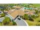 An aerial view showcasing the clubhouse entrance with landscaped grounds and a roundabout driveway at 17704 Gawthrop Dr # 303, Lakewood Ranch, FL 34211