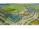 An aerial view showing tennis courts, a swimming pool, clubhouse, and residential area within the community at 17704 Gawthrop Dr # 303, Lakewood Ranch, FL 34211