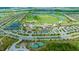 Aerial view of the vibrant community featuring a lavish clubhouse, pools, tennis courts, and well-manicured lawns at 17704 Gawthrop Dr # 303, Lakewood Ranch, FL 34211