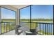Screened balcony with golf course and lake views and outdoor seating at 17704 Gawthrop Dr # 303, Lakewood Ranch, FL 34211