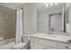 Bathroom featuring a shower-tub combination, a vanity with white top and framed mirror at 17704 Gawthrop Dr # 303, Lakewood Ranch, FL 34211