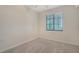 Neutral bedroom featuring carpeted floors and a window with blinds at 17704 Gawthrop Dr # 303, Lakewood Ranch, FL 34211