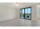 Bright bedroom with tile flooring and sliding glass doors to a balcony at 17704 Gawthrop Dr # 303, Lakewood Ranch, FL 34211