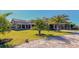 View of the impressive community clubhouse with lush landscaping and ample parking at 17704 Gawthrop Dr # 303, Lakewood Ranch, FL 34211