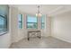 Dining room with three large windows, tile flooring, and table at 17704 Gawthrop Dr # 303, Lakewood Ranch, FL 34211