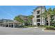 Three story condominium building with covered parking, handicap access, and mature landscaping at 17704 Gawthrop Dr # 303, Lakewood Ranch, FL 34211