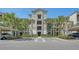 Three story condominium building in tropical setting with covered parking and handicap parking spaces at 17704 Gawthrop Dr # 303, Lakewood Ranch, FL 34211