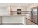 Well-lit kitchen with an island, stainless steel appliances, and plenty of cabinet space at 17704 Gawthrop Dr # 303, Lakewood Ranch, FL 34211