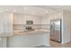 Spacious kitchen featuring an island, stainless steel appliances, and ample cabinet space at 17704 Gawthrop Dr # 303, Lakewood Ranch, FL 34211