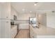 Bright kitchen with stainless appliances, granite countertops, and white cabinetry at 17704 Gawthrop Dr # 303, Lakewood Ranch, FL 34211