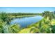Scenic view of a lake and golf course framed by palm trees and lush greenery at 17704 Gawthrop Dr # 303, Lakewood Ranch, FL 34211
