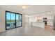 Open floor plan with sliding glass doors to a balcony and kitchen with an island at 17704 Gawthrop Dr # 303, Lakewood Ranch, FL 34211