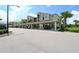 Covered parking for condominium with multiple parking spaces and mature landscaping at 17704 Gawthrop Dr # 303, Lakewood Ranch, FL 34211