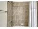Shower tub combination, tiled walls, shower curtain and chrome fixtures at 17704 Gawthrop Dr # 303, Lakewood Ranch, FL 34211