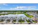 An aerial view of new residential construction surrounding a pond with a fountain in a beautiful community at 18510 Midsummer Pl, Venice, FL 34293