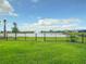 Fenced backyard offers a view of the water feature in the community at 18510 Midsummer Pl, Venice, FL 34293