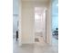 Bathroom entrance with a shower-tub combo and wainscoting on the wall at 18510 Midsummer Pl, Venice, FL 34293