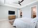 View of bedroom featuring a TV, dresser and door leading to the bathroom at 18510 Midsummer Pl, Venice, FL 34293
