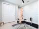 Bedroom with large closet, tile floors, and neutral paint, suitable for use as a home gym with fitness equipment at 18510 Midsummer Pl, Venice, FL 34293