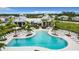 Aerial view of a luxurious community pool and lounge area, perfect for relaxation and social gatherings at 18510 Midsummer Pl, Venice, FL 34293