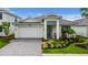 Charming single-story home featuring a well-manicured front yard and neutral paint at 18510 Midsummer Pl, Venice, FL 34293