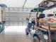 View of a garage showcasing a golf cart and a bright, open space for parking and storage at 18510 Midsummer Pl, Venice, FL 34293