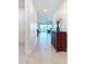 Bright hallway with tile flooring leads to the open-concept living spaces at 18510 Midsummer Pl, Venice, FL 34293